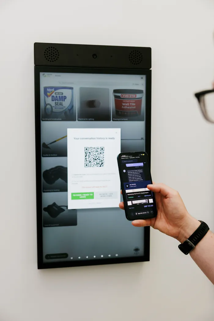 A visitor photographing a QR code to take their RAVO conversation with them